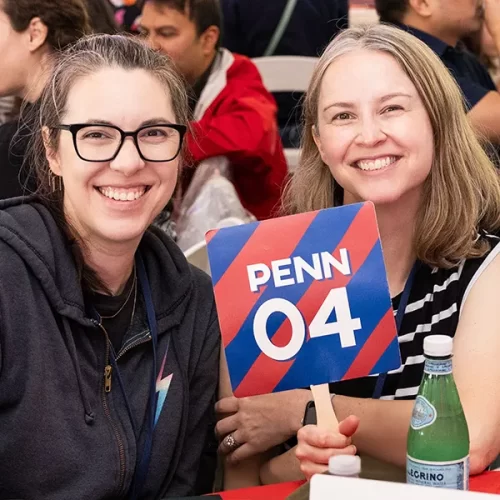Two alumni from the Class of 2004 smile during a reunion event