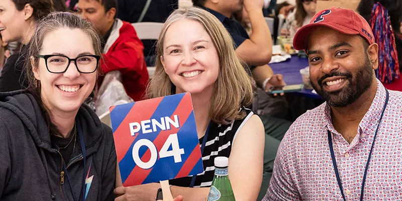Two alumni from the Class of 2004 smile during a reunion event
