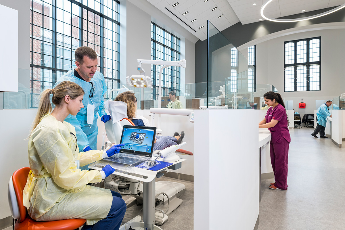 Penn Dental practitioners study images from examinations in a clinical setting.