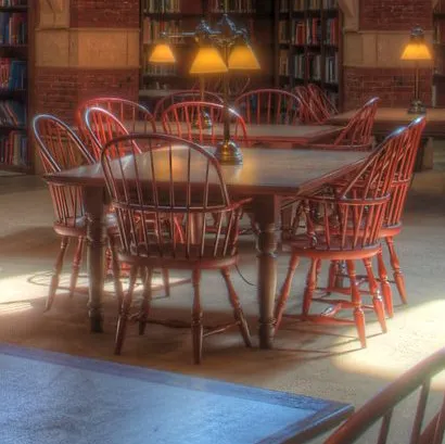 A table surrounded by chairs inside Fisher Fine Arts Library at the University of Pennsylvania.
