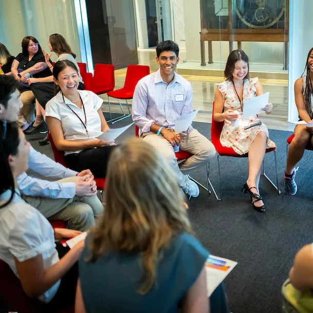 A group of students sitting in a circle at the University of Pennsylvania's Van Pelt-Dietrich Library Center, engaged in a discussion.