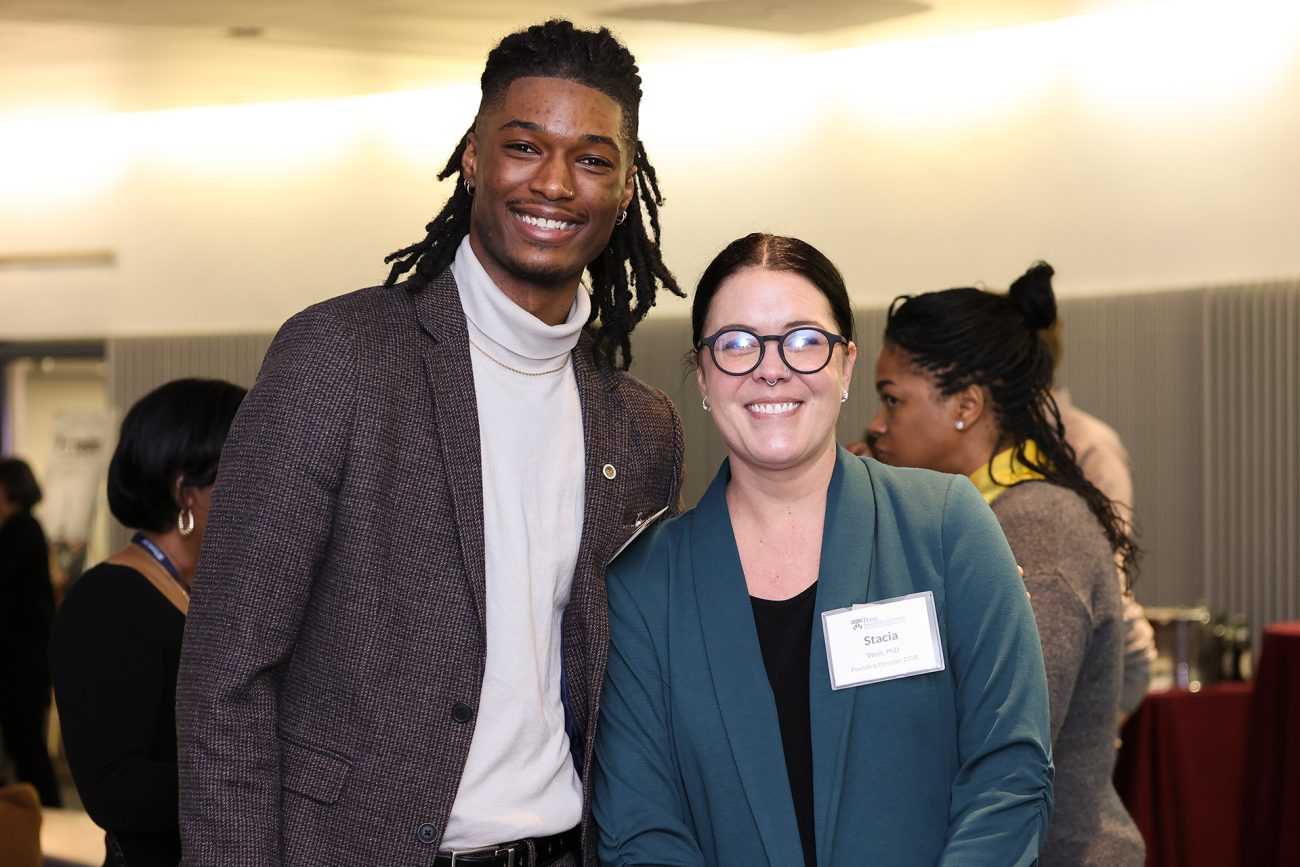 Matthew Encarnación, SPP’24, stands alongside Stacia West while both smile for the camera.