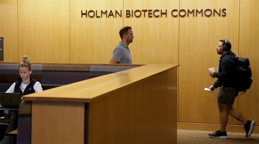 Students work and walk through the Holman Biotech Commons at the Penn Libraries.